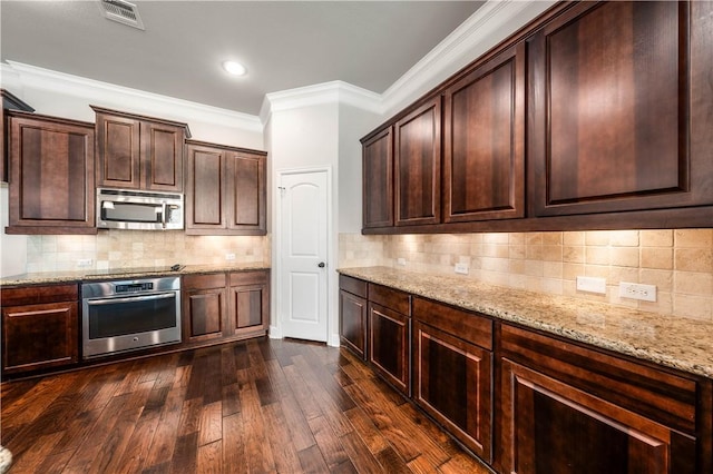 kitchen with light stone countertops, appliances with stainless steel finishes, dark hardwood / wood-style flooring, backsplash, and crown molding