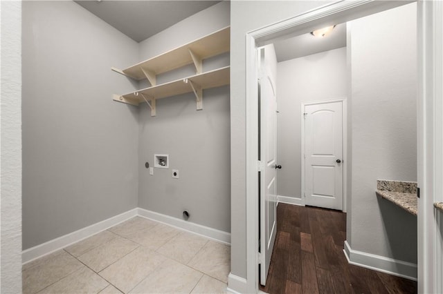 laundry area with hookup for a washing machine, light hardwood / wood-style flooring, and electric dryer hookup