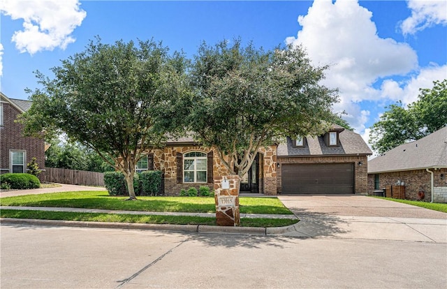 view of front of property featuring a front yard and a garage