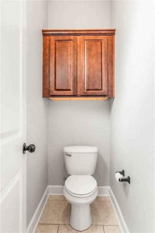 bathroom with tile patterned flooring and toilet