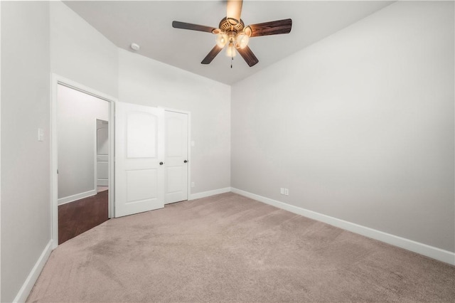 unfurnished bedroom with light carpet, a closet, and ceiling fan