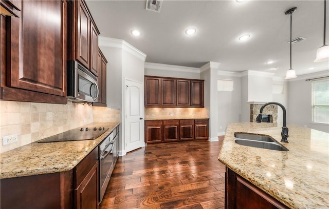 kitchen featuring sink, dark hardwood / wood-style floors, pendant lighting, appliances with stainless steel finishes, and ornamental molding