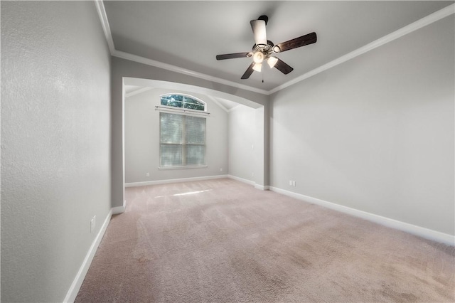 empty room with carpet floors, crown molding, and ceiling fan