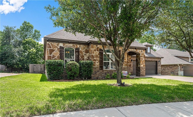 view of front of house featuring a garage and a front lawn