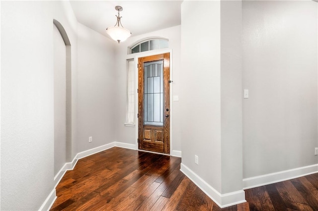 entryway with dark hardwood / wood-style flooring