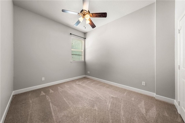 carpeted spare room featuring ceiling fan