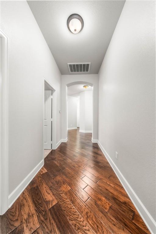 hallway featuring dark hardwood / wood-style floors