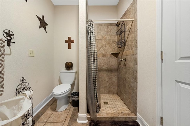 bathroom featuring tile patterned floors, toilet, and walk in shower