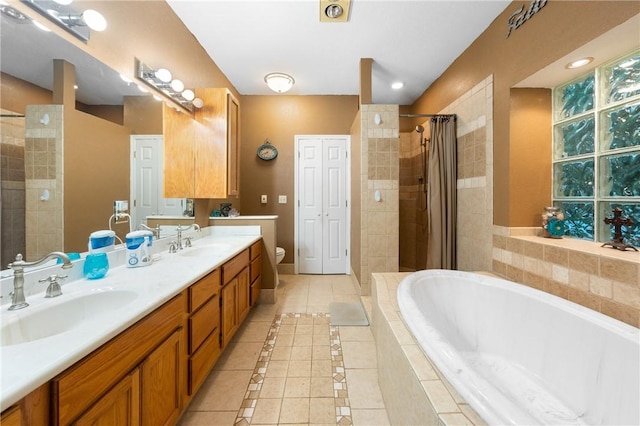 full bathroom featuring toilet, shower with separate bathtub, vanity, and tile patterned floors