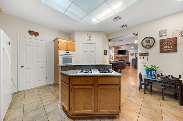 kitchen featuring light tile patterned floors and white appliances