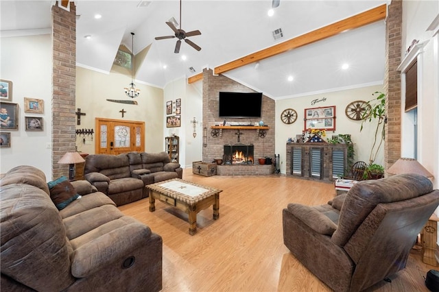 living room with light wood-type flooring, a brick fireplace, ornamental molding, ceiling fan, and high vaulted ceiling