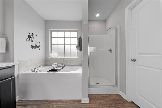 bathroom featuring hardwood / wood-style floors, vanity, and separate shower and tub