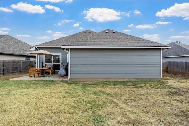 rear view of property featuring a patio area and a yard