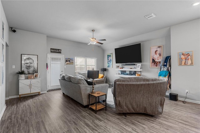 living room featuring wood-type flooring and ceiling fan