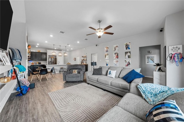 living room with ceiling fan and wood-type flooring