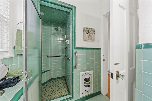 bathroom with a shower with door