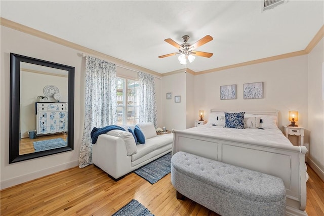 bedroom with light wood-type flooring, ceiling fan, and crown molding