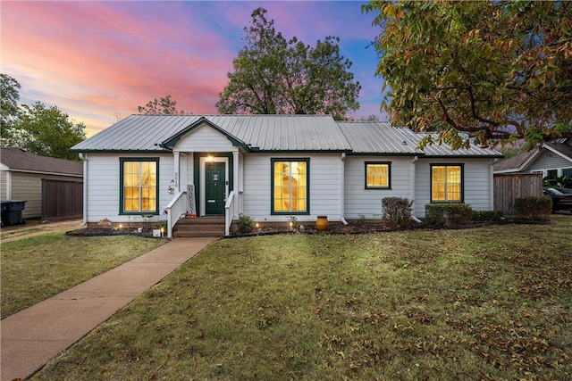 ranch-style home with a lawn