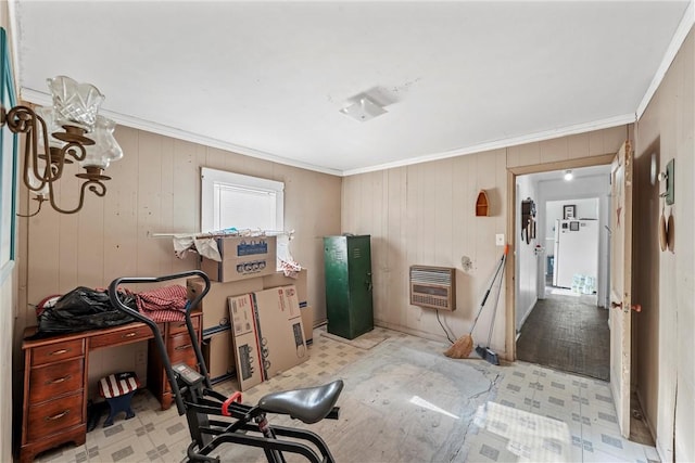 misc room with heating unit, wood walls, light hardwood / wood-style flooring, and ornamental molding