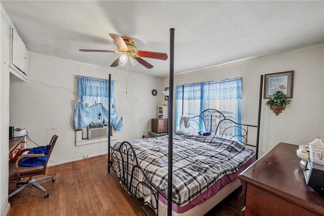 bedroom featuring ornamental molding, hardwood / wood-style flooring, ceiling fan, and cooling unit