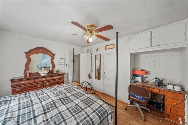 bedroom with ceiling fan, ornamental molding, and light wood-type flooring