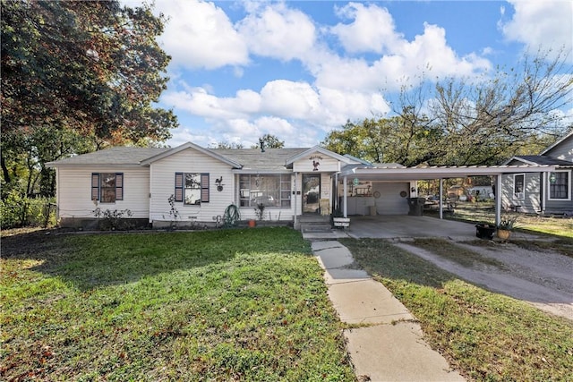 view of front facade with a front yard and a carport