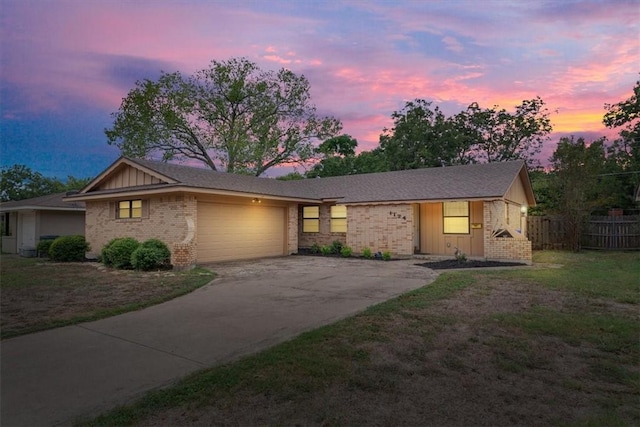 single story home with a garage and a lawn