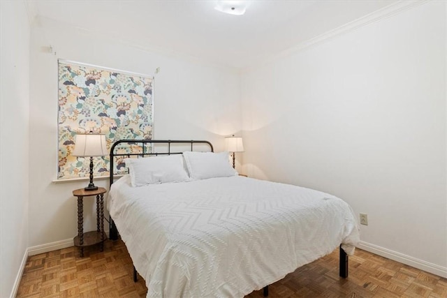 bedroom with crown molding and parquet floors