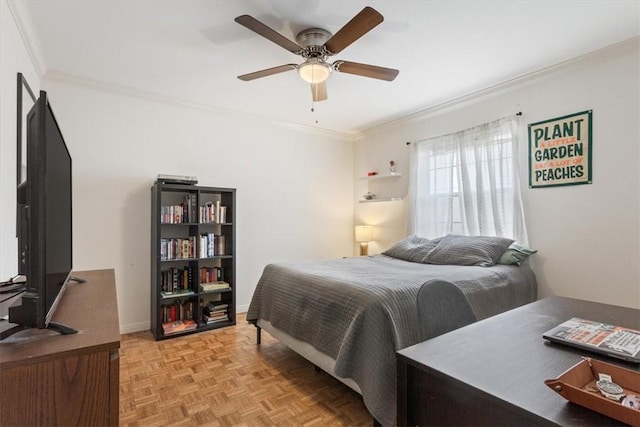 bedroom featuring ceiling fan, crown molding, and light parquet floors