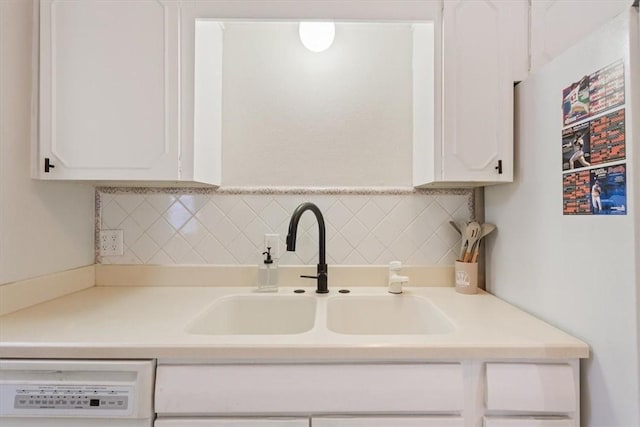 kitchen featuring white cabinets, tasteful backsplash, dishwasher, and sink