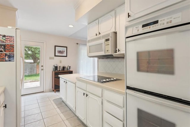 kitchen featuring white cabinetry, white appliances, light tile patterned floors, and tasteful backsplash