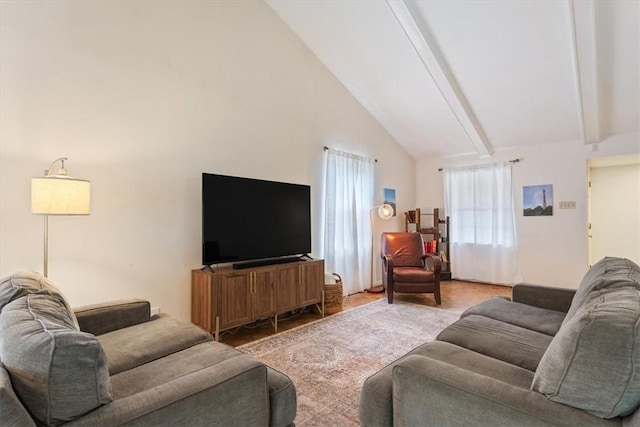 living room with beamed ceiling and high vaulted ceiling