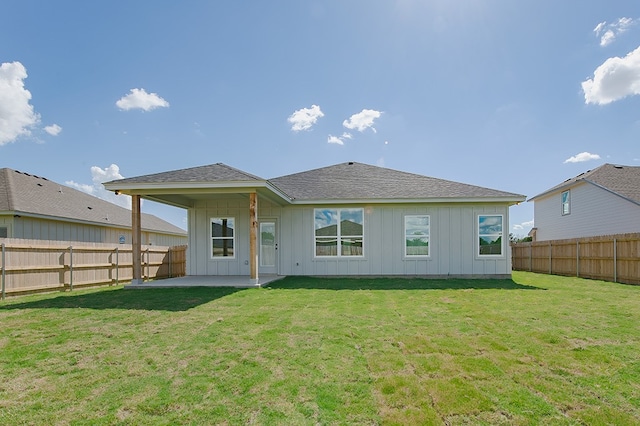 back of property with a patio area and a lawn