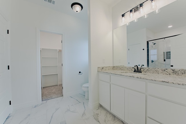 bathroom with vanity, toilet, and an enclosed shower