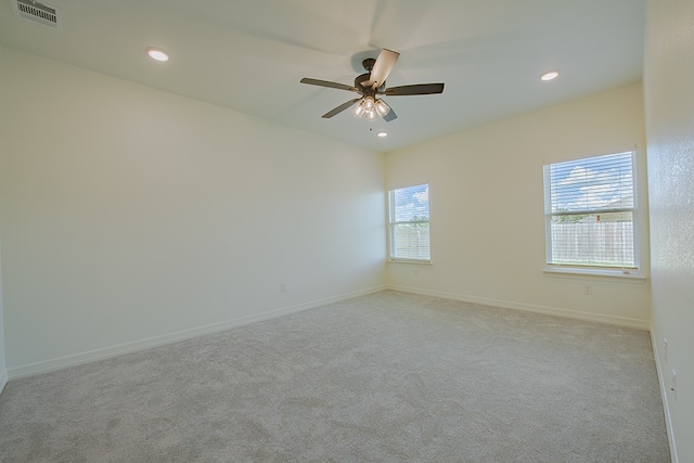 carpeted empty room featuring ceiling fan