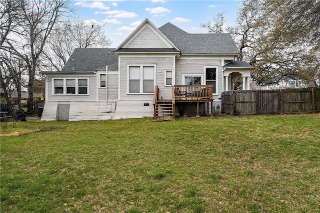 back of house with a gate, fence, roof with shingles, a wooden deck, and a yard