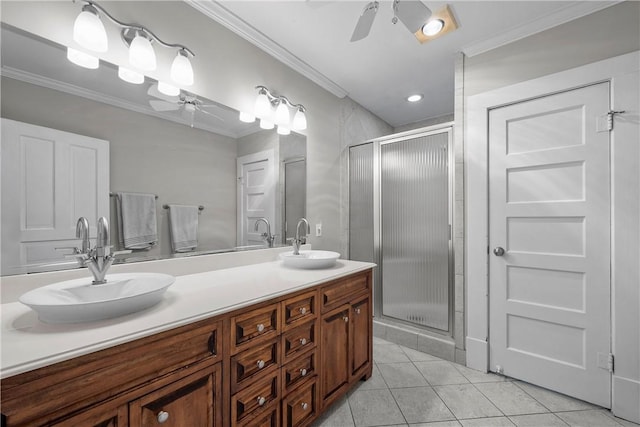 bathroom featuring crown molding, ceiling fan, and a sink