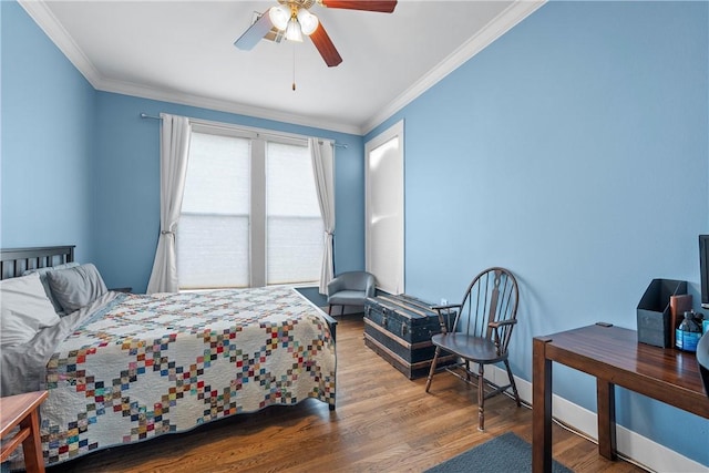 bedroom featuring crown molding, wood finished floors, baseboards, and ceiling fan