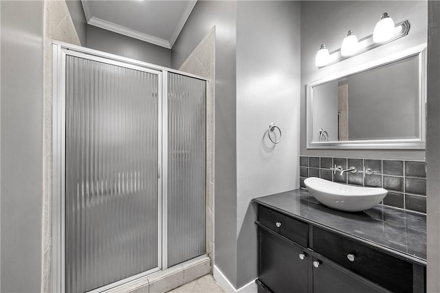 full bath with backsplash, vanity, a shower stall, and ornamental molding