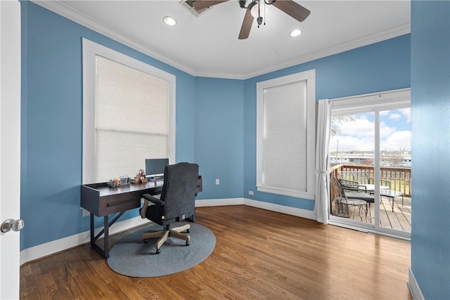 office area with baseboards, wood finished floors, visible vents, and ornamental molding