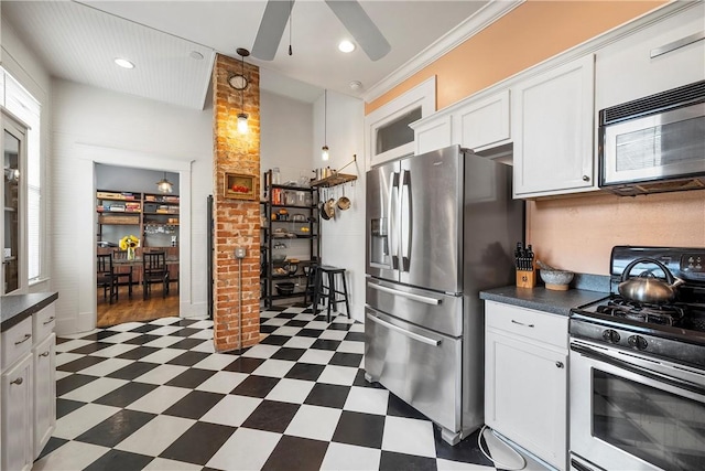 kitchen featuring dark countertops, ceiling fan, dark floors, appliances with stainless steel finishes, and white cabinetry