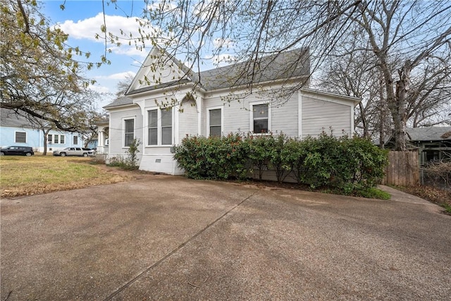 view of home's exterior featuring a yard, fence, and crawl space