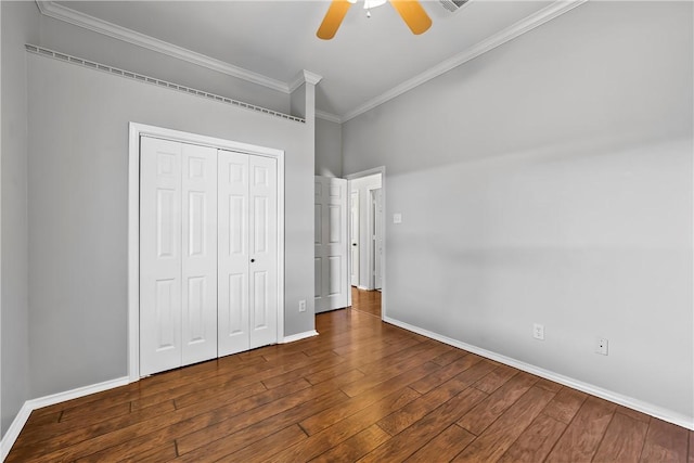 unfurnished bedroom featuring dark hardwood / wood-style flooring, ceiling fan, a closet, and crown molding