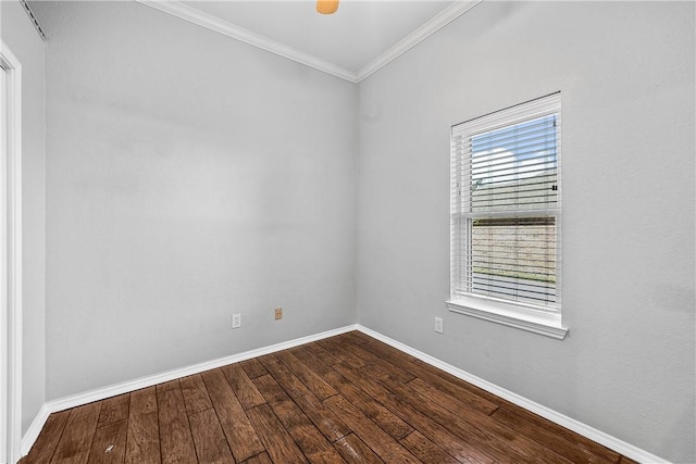 empty room with hardwood / wood-style floors and crown molding