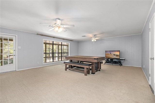 game room featuring light carpet, ceiling fan, and ornamental molding