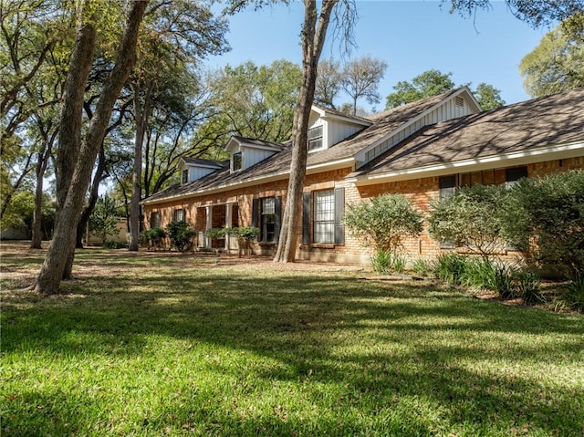 rear view of property with a lawn