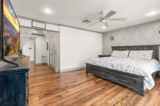 bedroom featuring wood-type flooring, ceiling fan, and ornamental molding