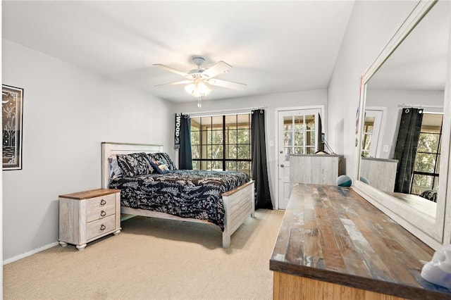 bedroom with ceiling fan and light carpet