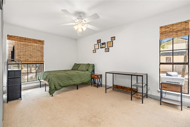 bedroom with ceiling fan and light colored carpet