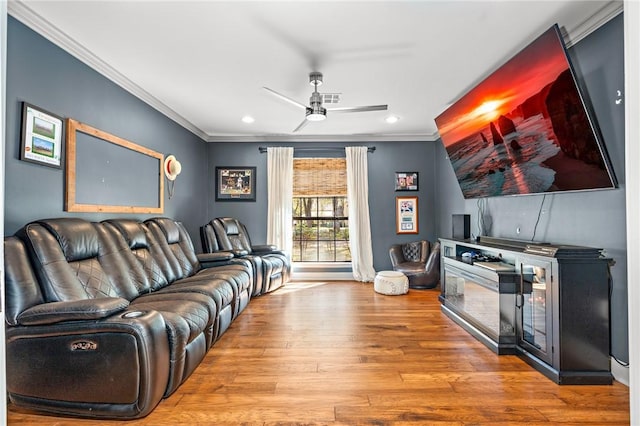 living room featuring ceiling fan, hardwood / wood-style floors, and ornamental molding